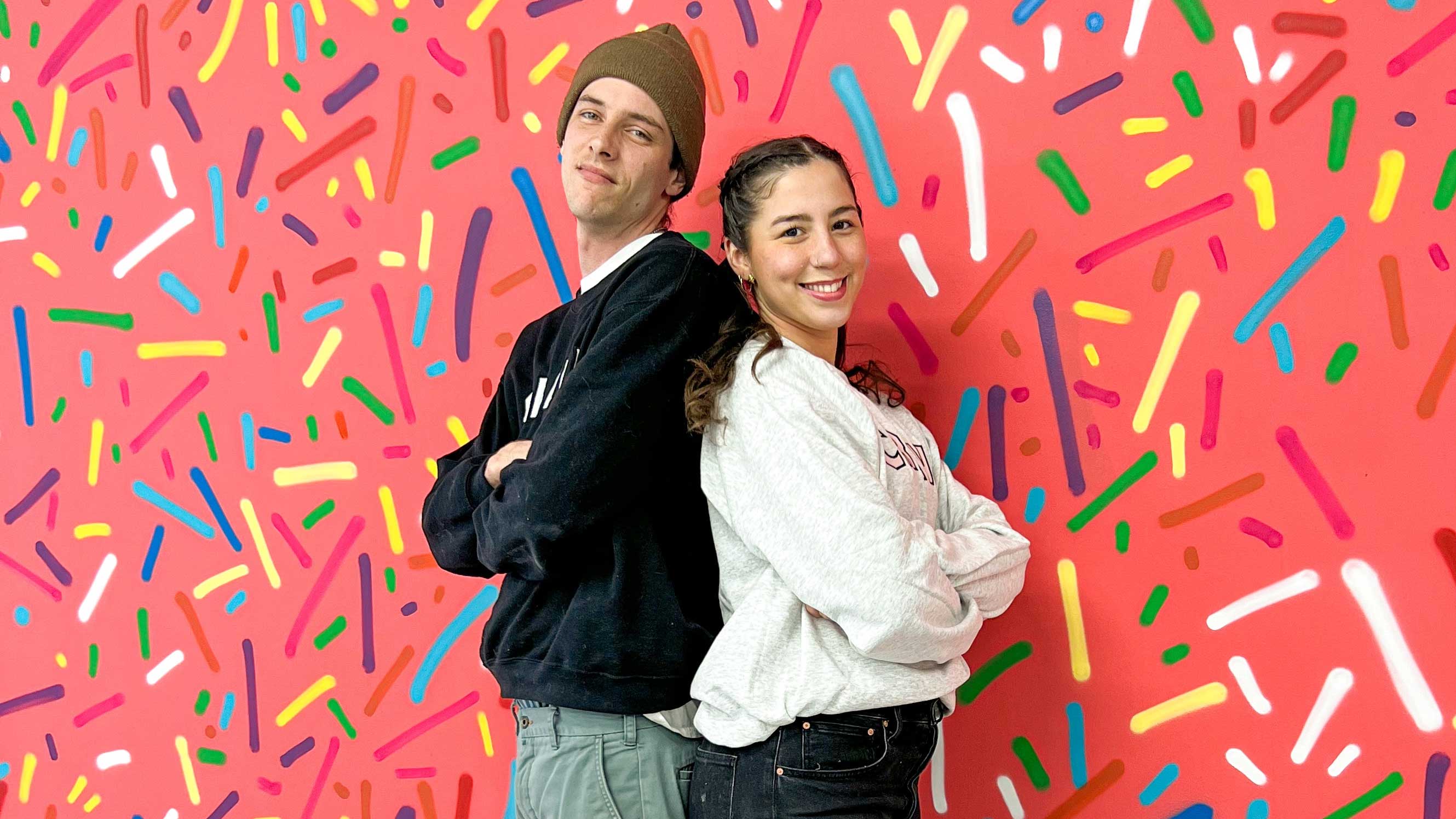 Owners of Crave Doughnuts standing back to back