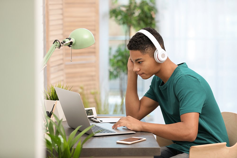 Teen boy using laptop 