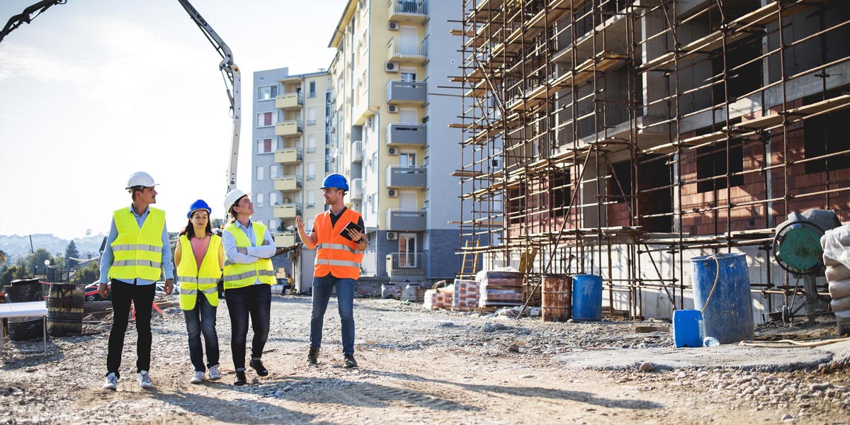 Construction workers at site reviewing document