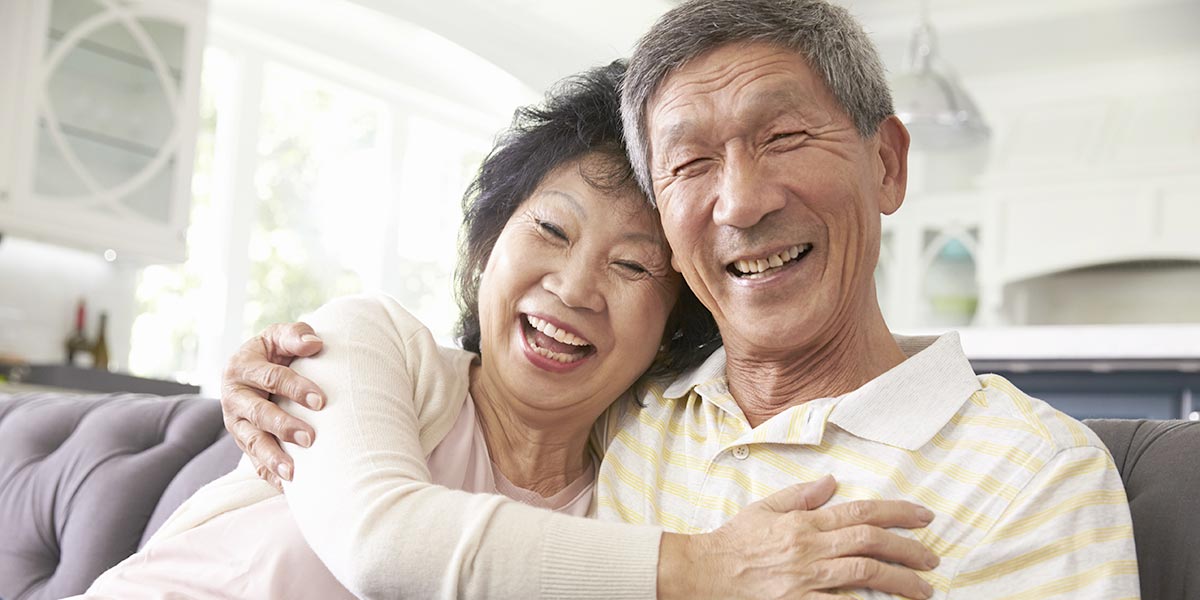 Two 55+ adults together smiling