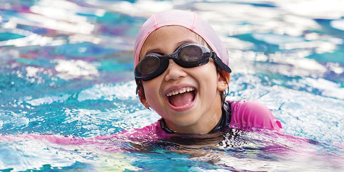 Girl smiling in pool