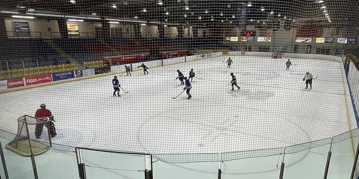 Hockey players on a pad of ice.
