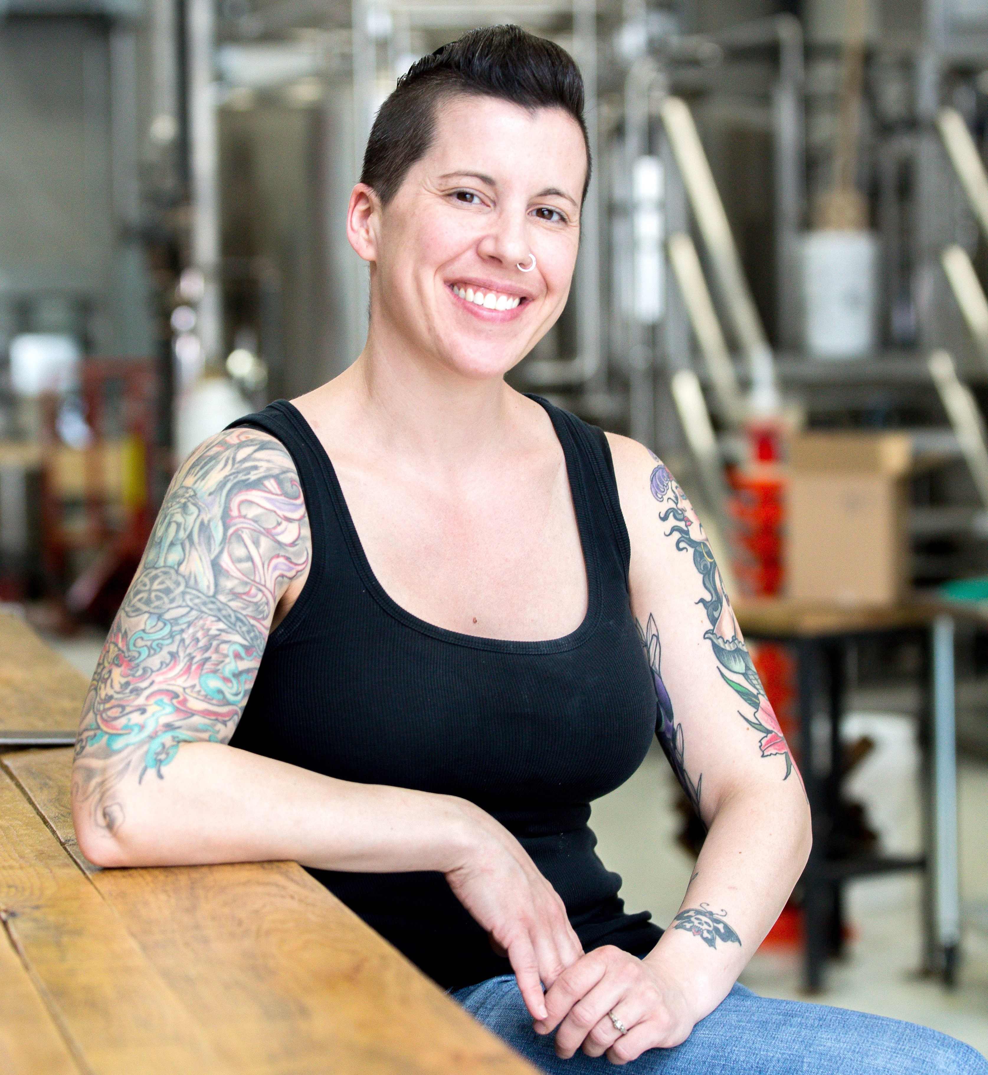 Erin Broadfoot, Founder and Head Brewer in front of steel fermenter