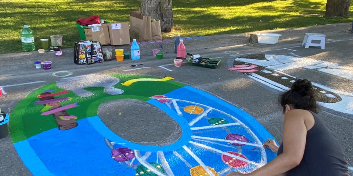 Roebuck Street artist drawing on road