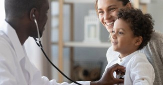 A doctor examining a child with a stethoscope.