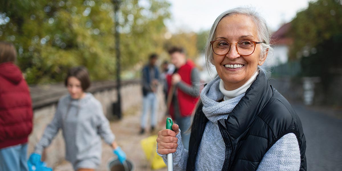 Woman smiling while volunteering at a community event