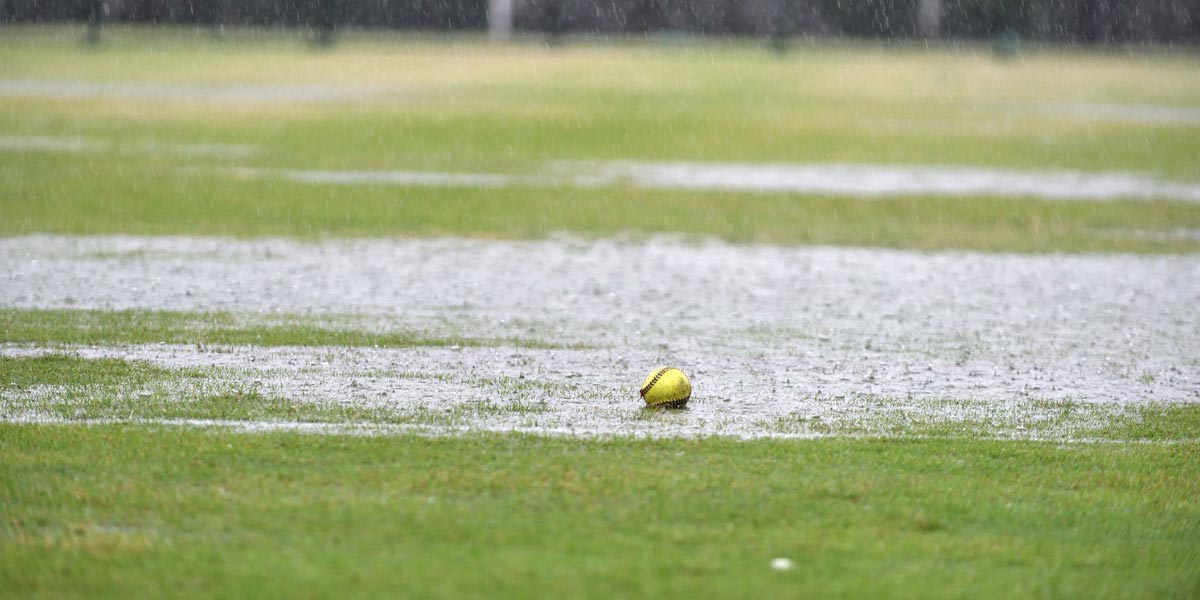 Field covered in water with a baseball on the ground