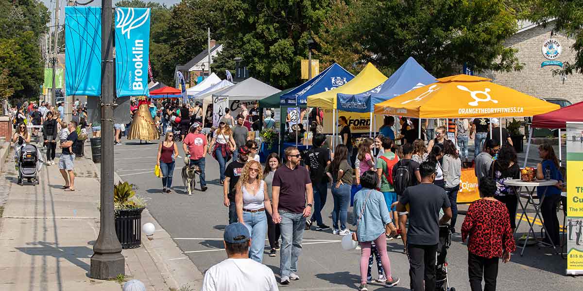 People walking down the street enjoying Harvest Festival