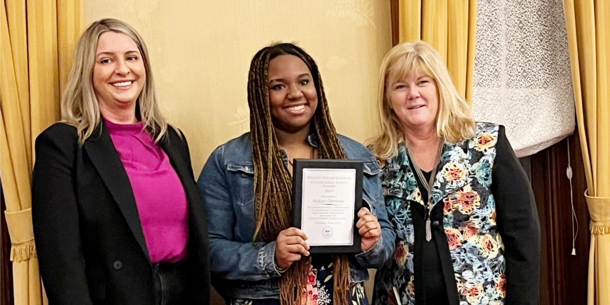 Youth award winner with Mayor Roy and a councillor