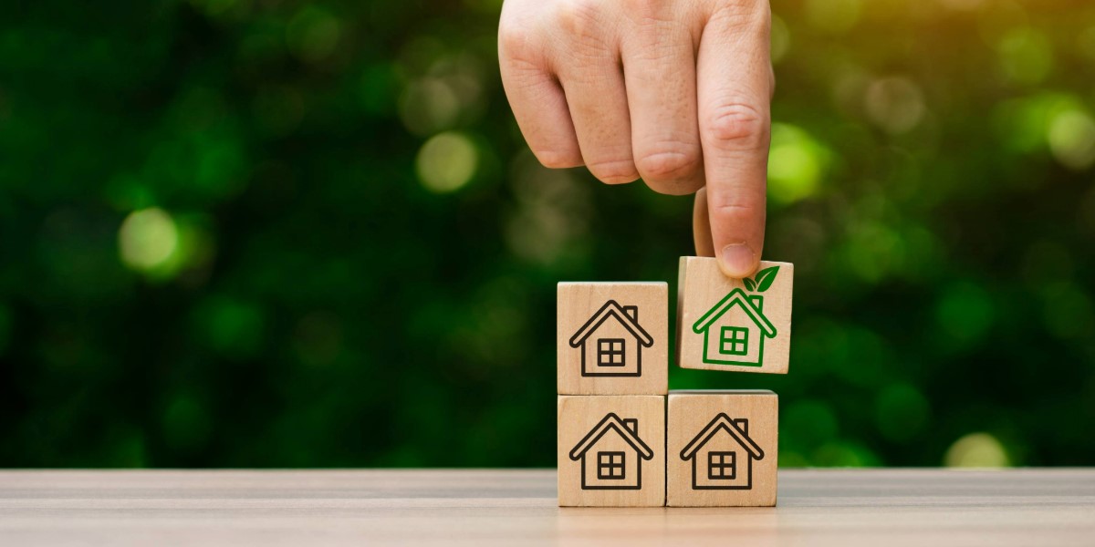 Building blocks with images of homes, including a green home.