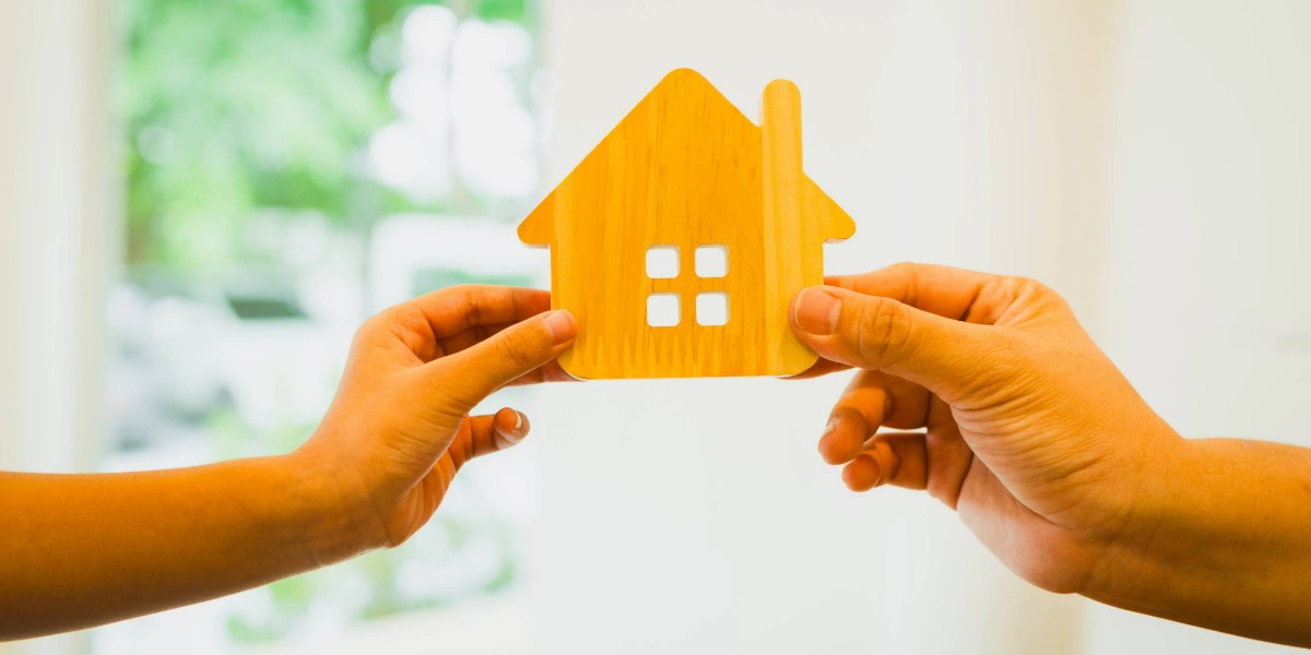 Two hands holding a wood house