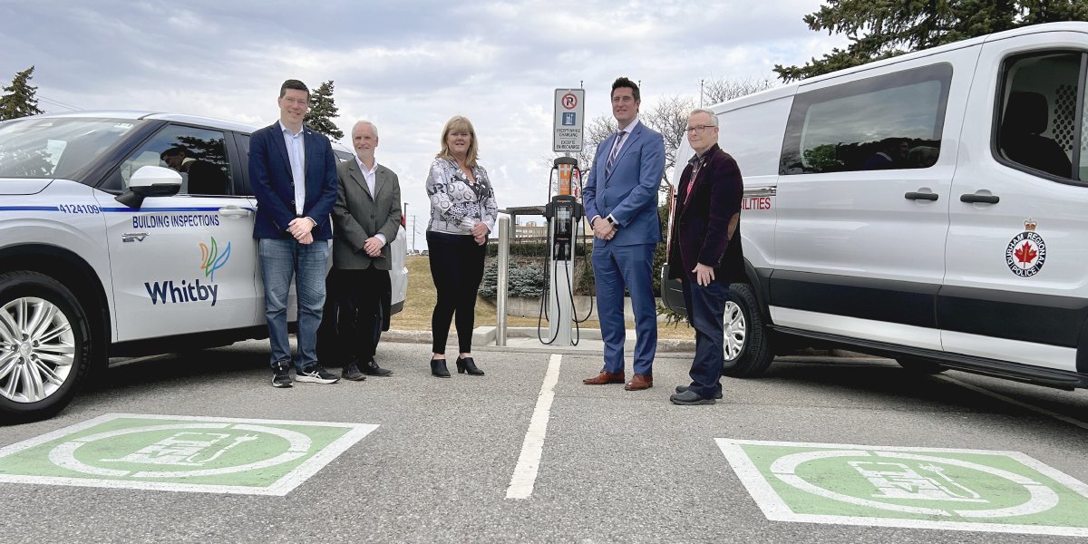 Group photo around an EV station.