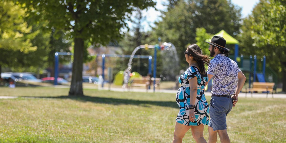Two adults holding hands walking in park