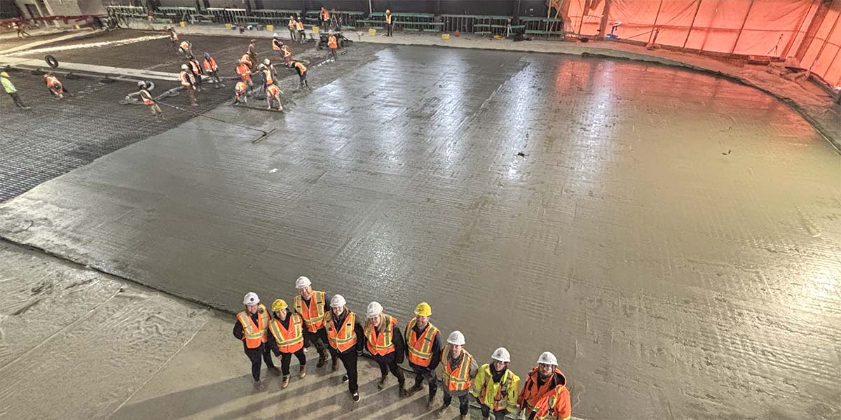 Mayor, Council and staff standing by the just-poured concrete arena pad