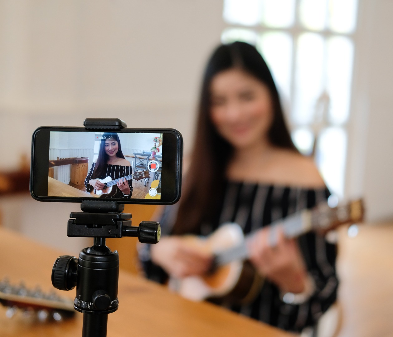 Woman live streaming a guitar performance