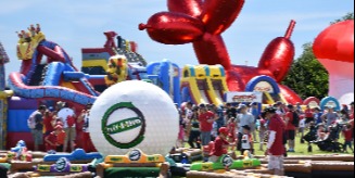 Canada Day event with bouncy castles and a large inflatable balloon animal