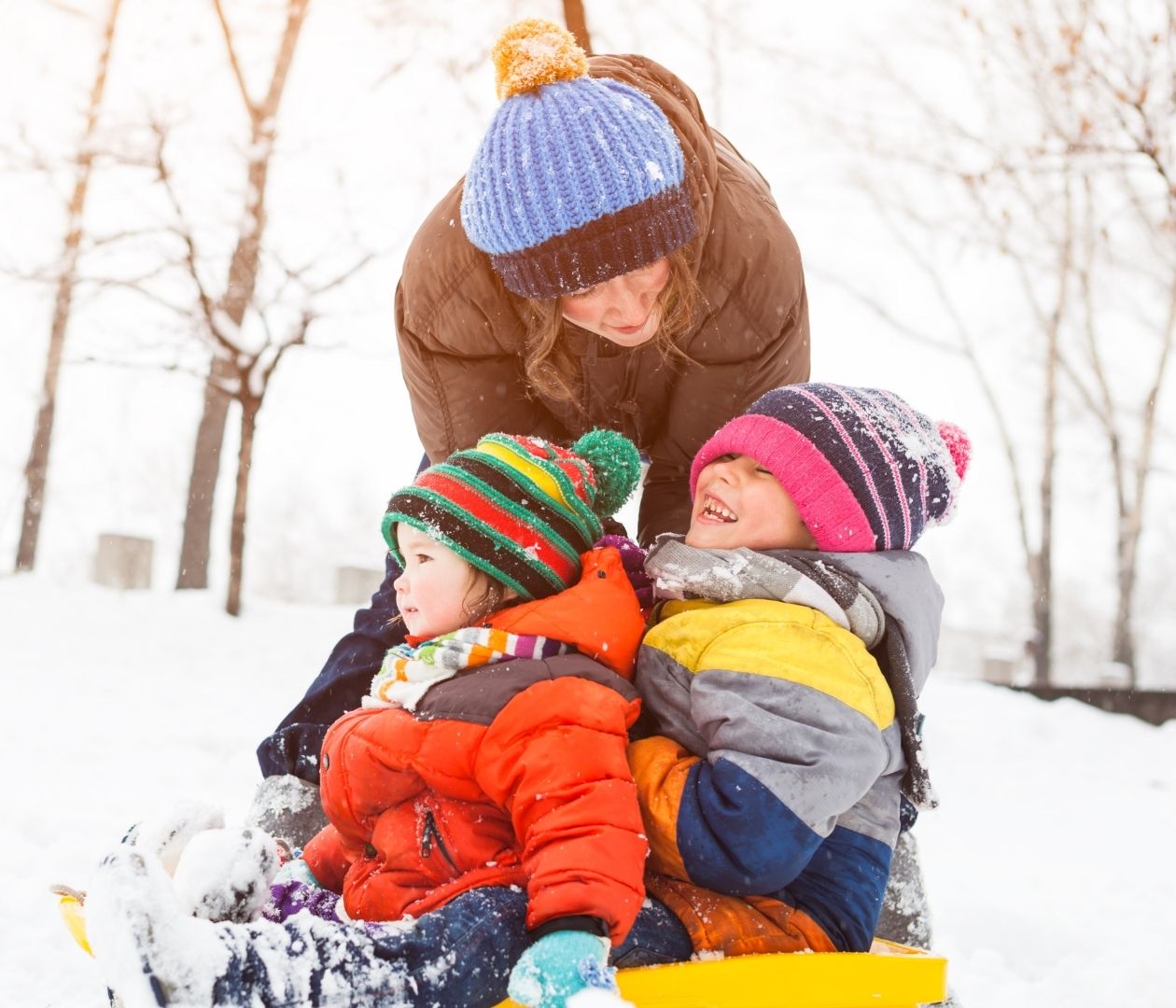 Family sledding outside in the winter