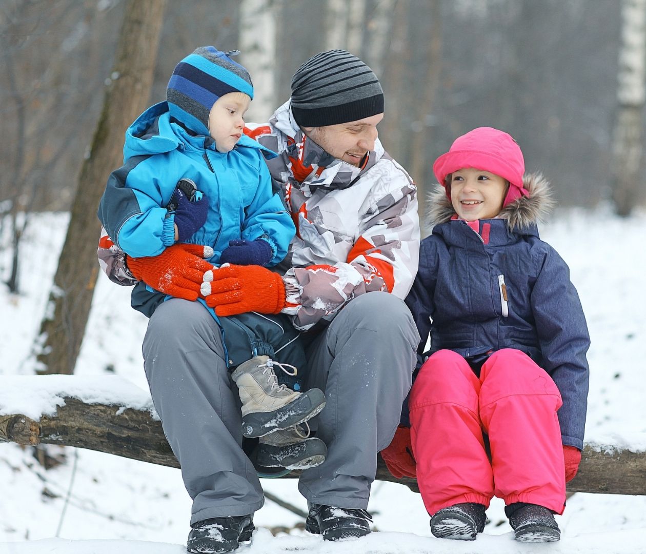 Family sitting outside in the winter