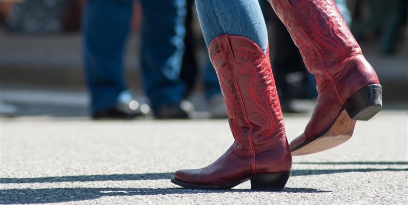 Close up of feet dancing with cowboy boots 