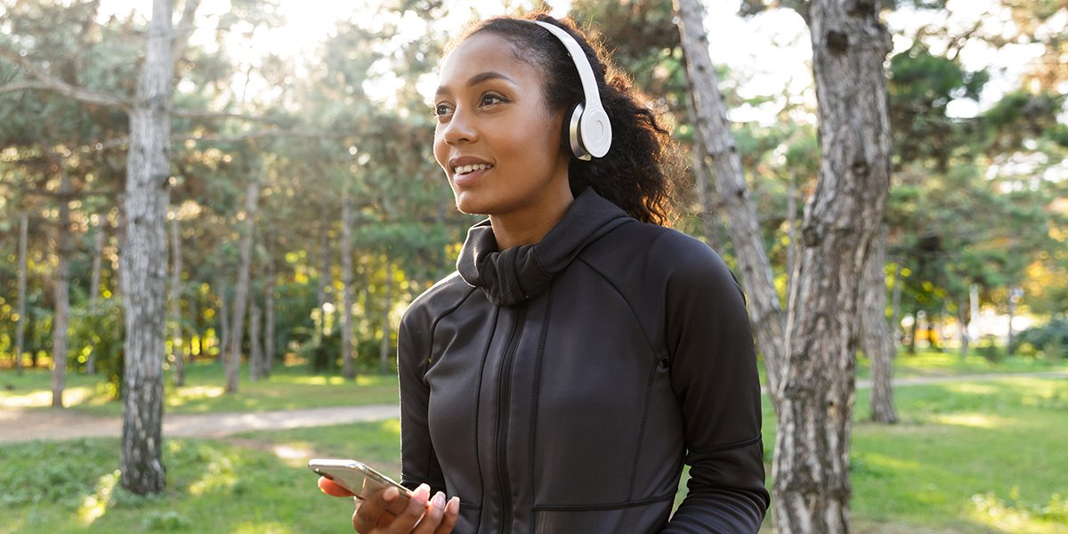 woman listening to music walking trails