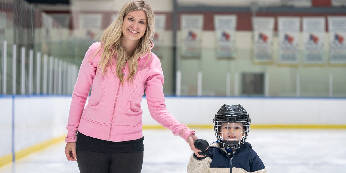 Mother helping son skate