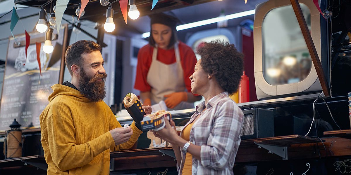People standing at food truck getting food