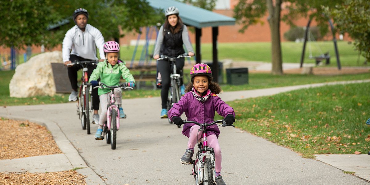 Family cycling on a trail