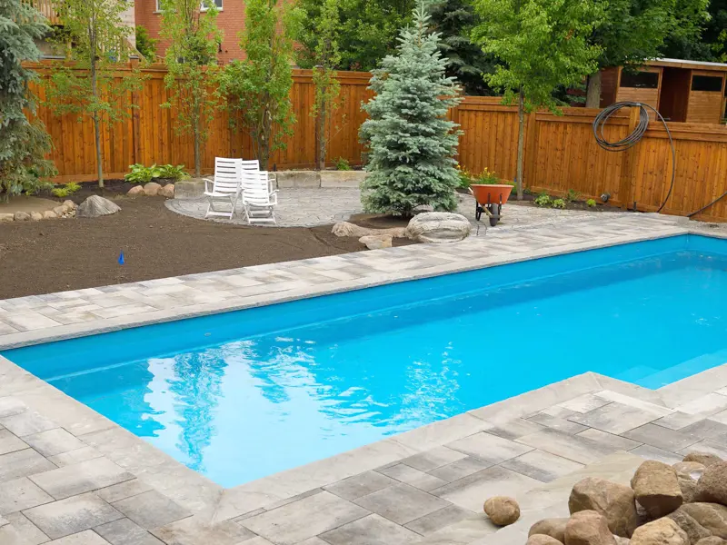 Newly constructed rectangle inground pool in a backyard