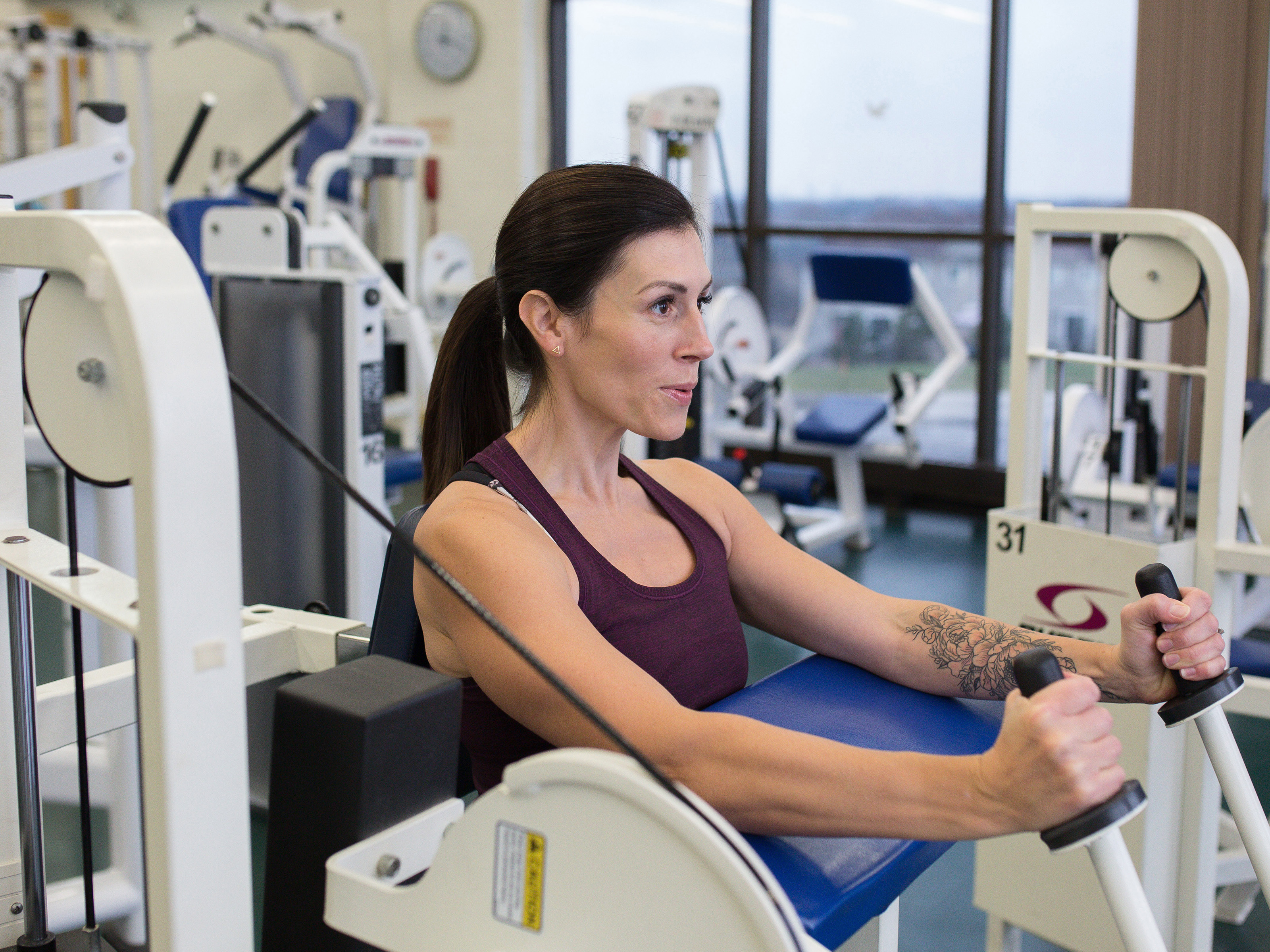 Woman working out on fitness machine at Whitby's Health Club