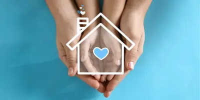 Graphic of house with heart in hands 