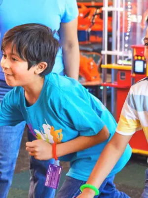 Two boys laughing while playing at Chuck E. Cheese 
