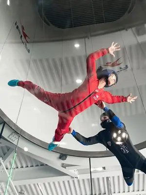 Two flyers inside indoor skydiving tunnel at iFly 