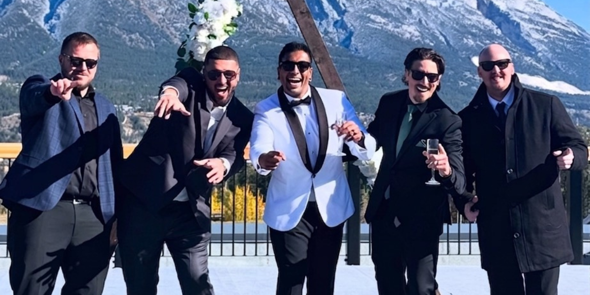 Musicians standing in front of a mountain