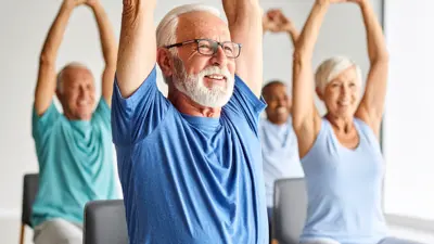 Group of senior people in a chair stretch class
