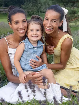 Two women at child smiling at camera in lavender field 