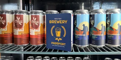Brewery Passport Booklet inside fridge with beer cans