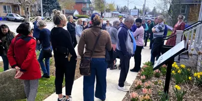 People gathered for walking tour outside museum 