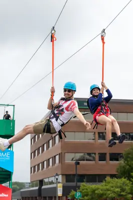 People flying on zip line 