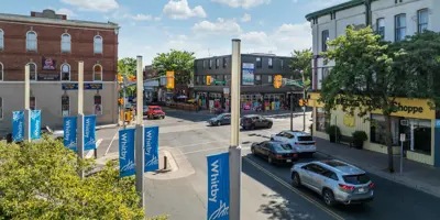 Main intersection in Downtown Whitby with historic buildings and Town banners on pole 
